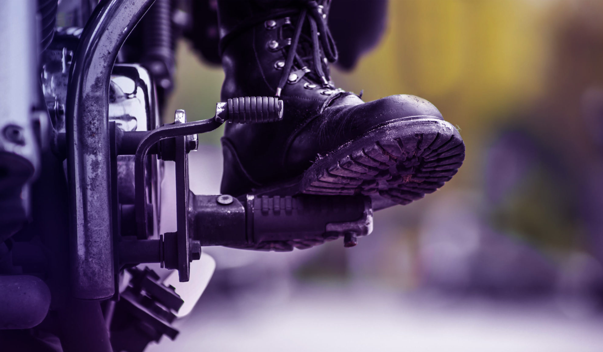 Member of the society riding a motorcycle boot close up