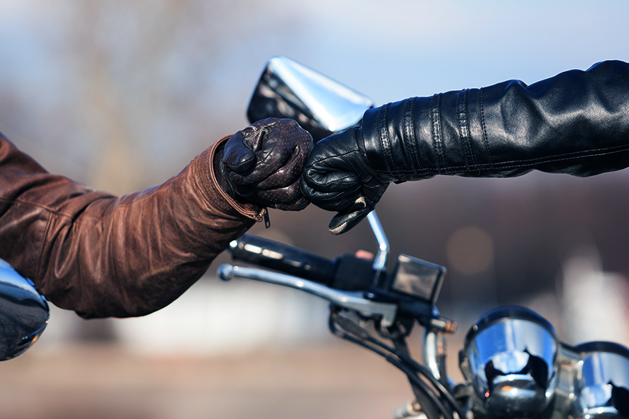 two members of the motorcycle family bumping their fists